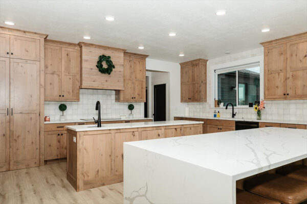 Custom built kitchen with two islands, granite counter tops and wood cabinets in Boise Idaho