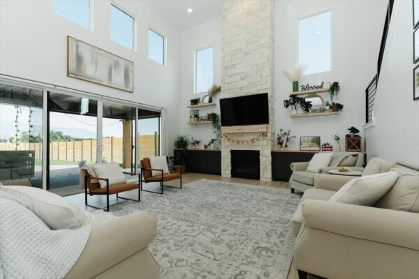 Spacious living room with fireplace and access to backyard, custom built in Boise idaho