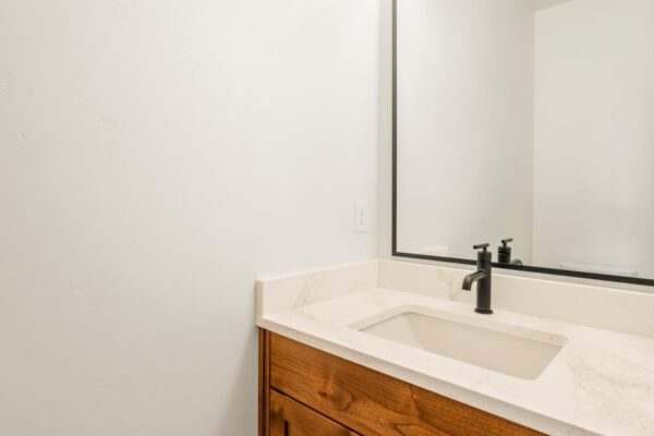 Custom built home bathroom view of sink and mirror